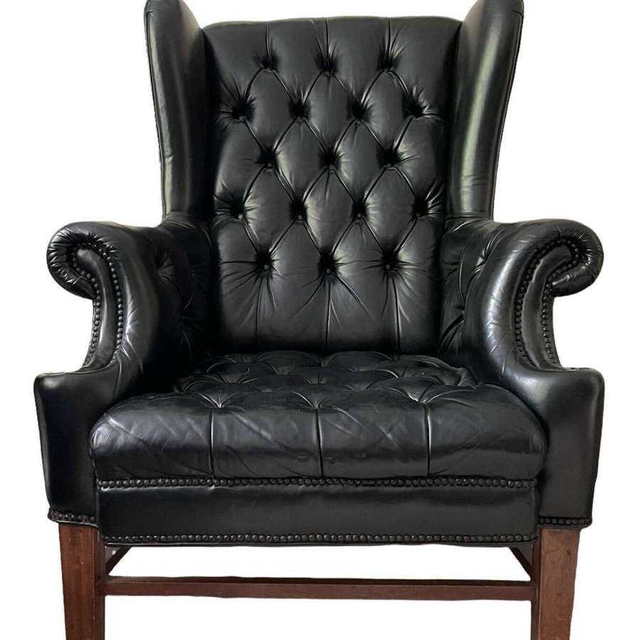 Large vintage black leather wing back chair.