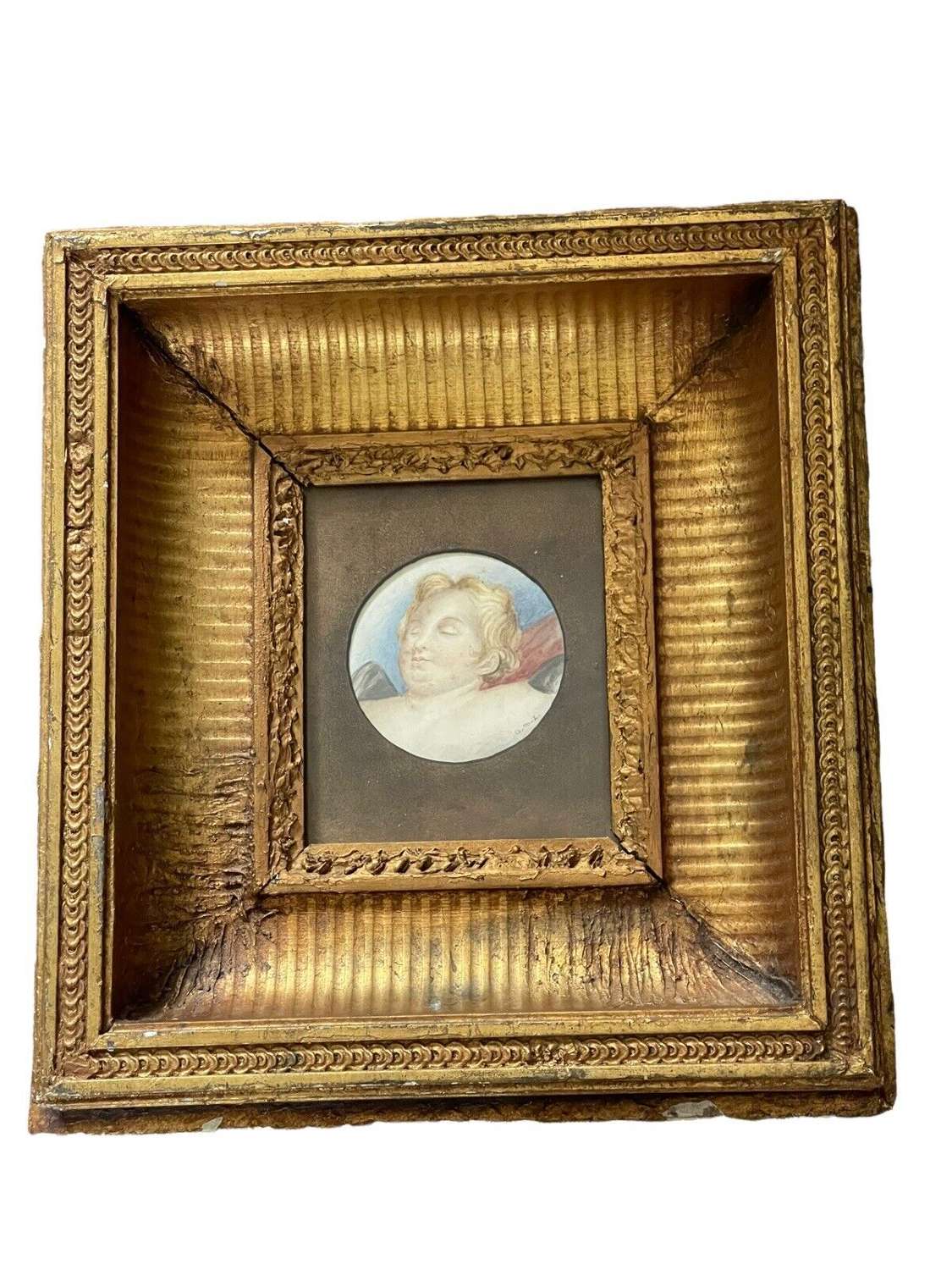 An antique study of a sleeping angel in a 19th Century gilded frame.